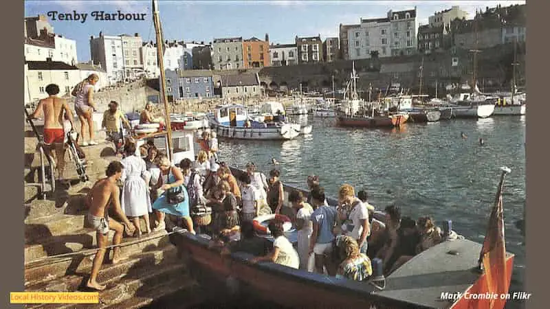 1980s postcard of tourists on a pleasure boat at Tenby Harbour