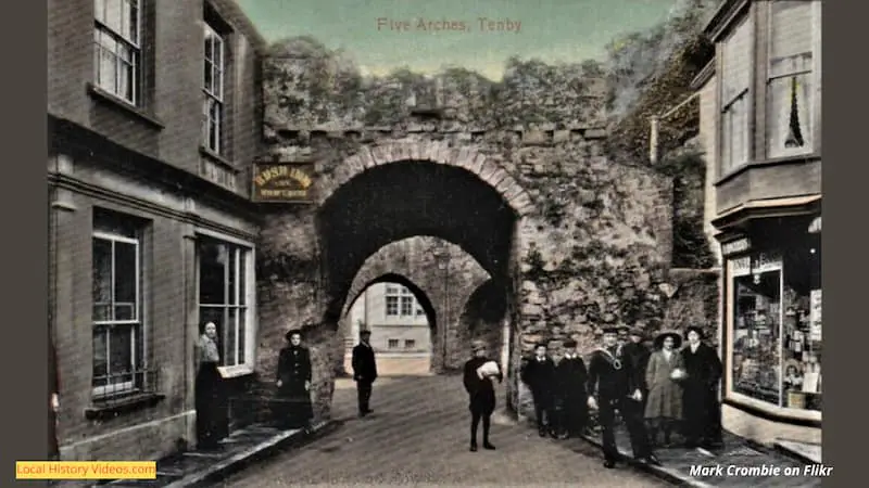 old photo of the Five Arches at Tenby, including local people and businesses