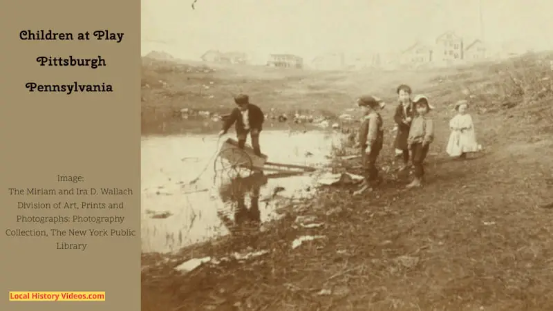 Children playing in a water hole and rough ground close to housing at Pittsburgh, Pennsylvania