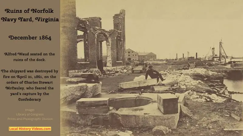 Old photo of Alfred Waud sitting on rubble at the ruined docks of the Norfolk Navy Yard, Virginia, taken during the American Civil War in December 1864