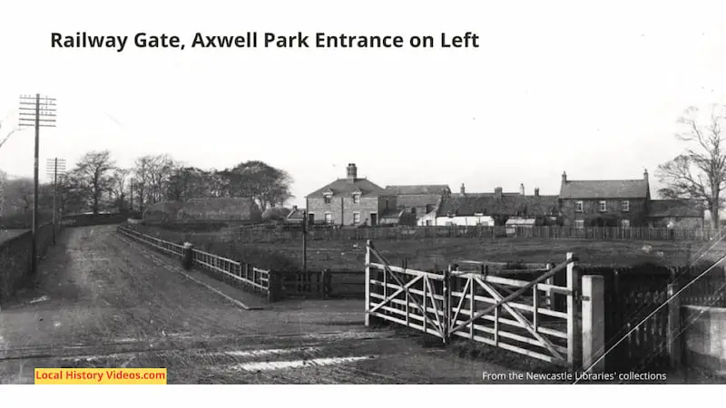 Old photo of the railway gate close to the entrance of Axwell Park, with buildings beyond