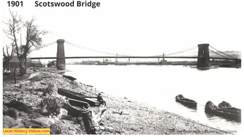 1901 photo of the old Scotswood Bridge, known locally as the Chain Bridge, with boats at the side of the River Tyne