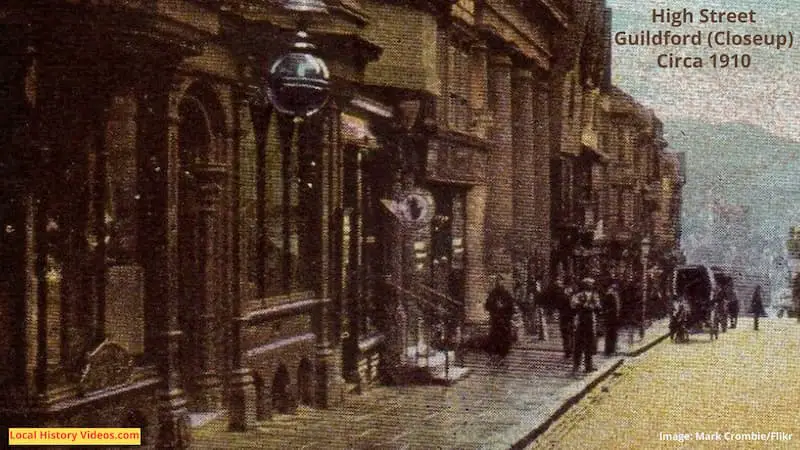 Closeup of an old photo postcard of Guildford High Street, taken around 1910