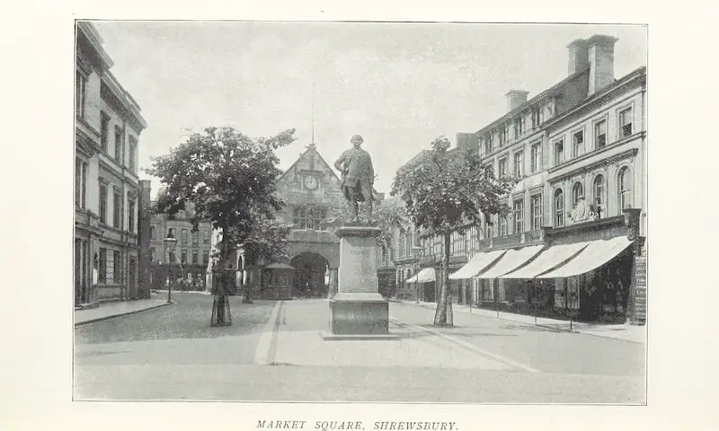 Old photo of the Market Square at Shrewsbury. Image credit "Samples from the Note Books of an Uncommercial Traveller [Notes of travel in England. With illustrations.] (Reprinted from the 'Diary and Buyers' Guide,' 1898.)" by Mortimer, John, Published 1898, British Library/Flikr