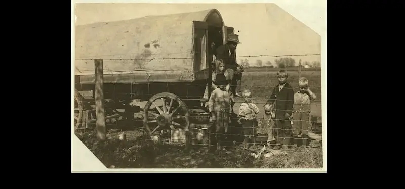 An old photo of the prairie-wagon home of a family of itinerant beet workers camped near Fort Collins, Colorado in 1915