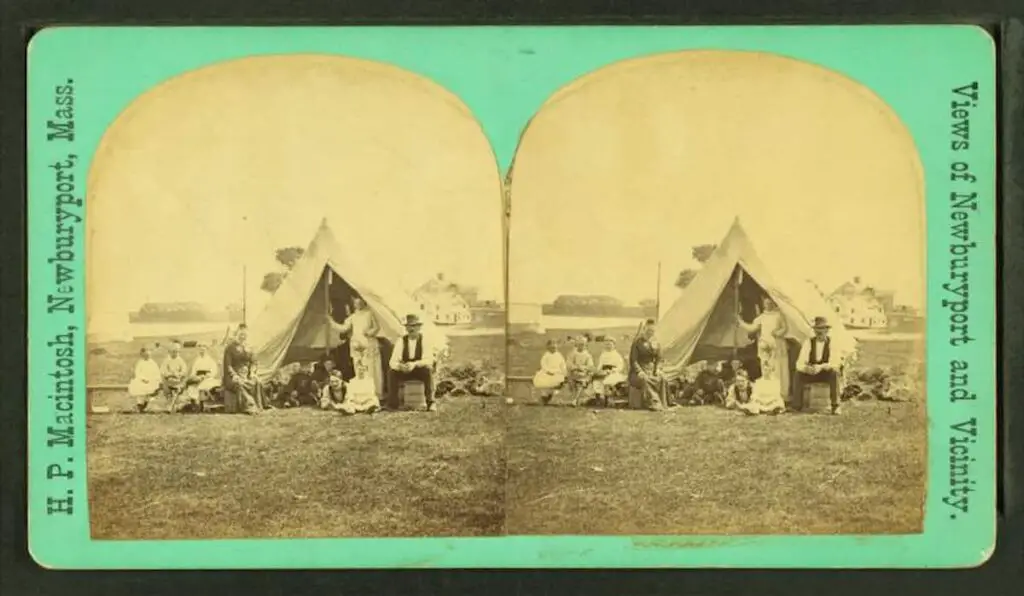 Old stereograph image of a large family group camping in a tent in the Newburyport vicinity