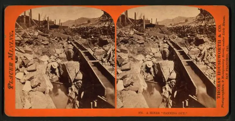 Old stereograph of a miner panning out with a sieve in the 1860s