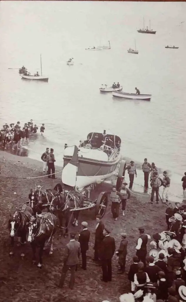 Old photo postcard of horses pulling the lifeboat on the beach at Teignmouth, Devon, England