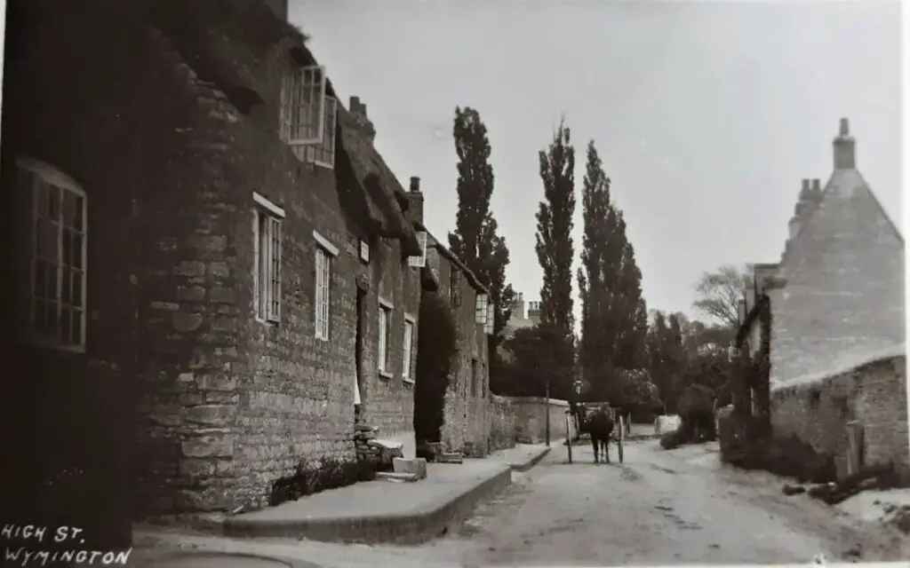 Vintage postcard of the High Street at Wymington, Bedfordshire, circa 1906