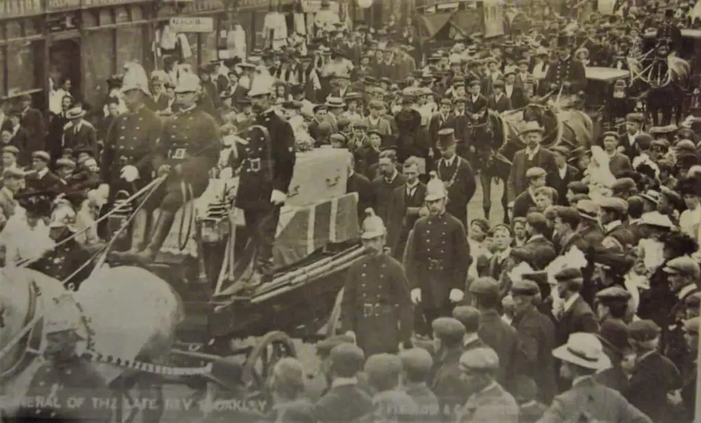 Vintage postcard of the funeral procession for Rev Oakley at High Wycombe, with firemen in attendance
