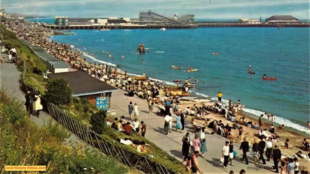 Old photo postcard of the beach, pier and rollercoaster at Clacton-on-Sea