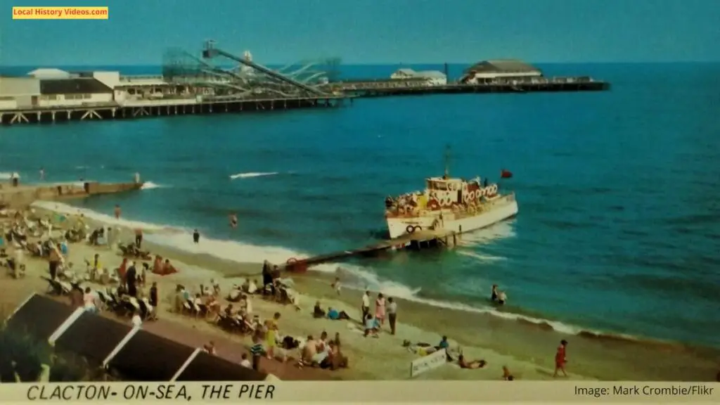 Old photo postcard of the beach, pier and rollercoaster at Clacton-on-Sea, Essex