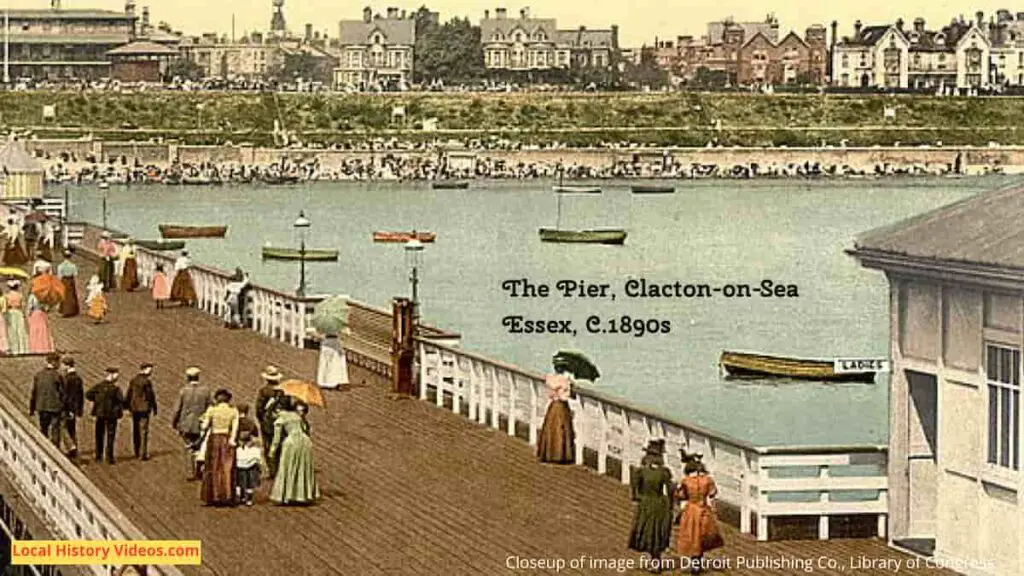Seafront homes in a closeup of an old photo postcard of the end of the pier at Clacton-on-Sea, Essex, in the 1890s